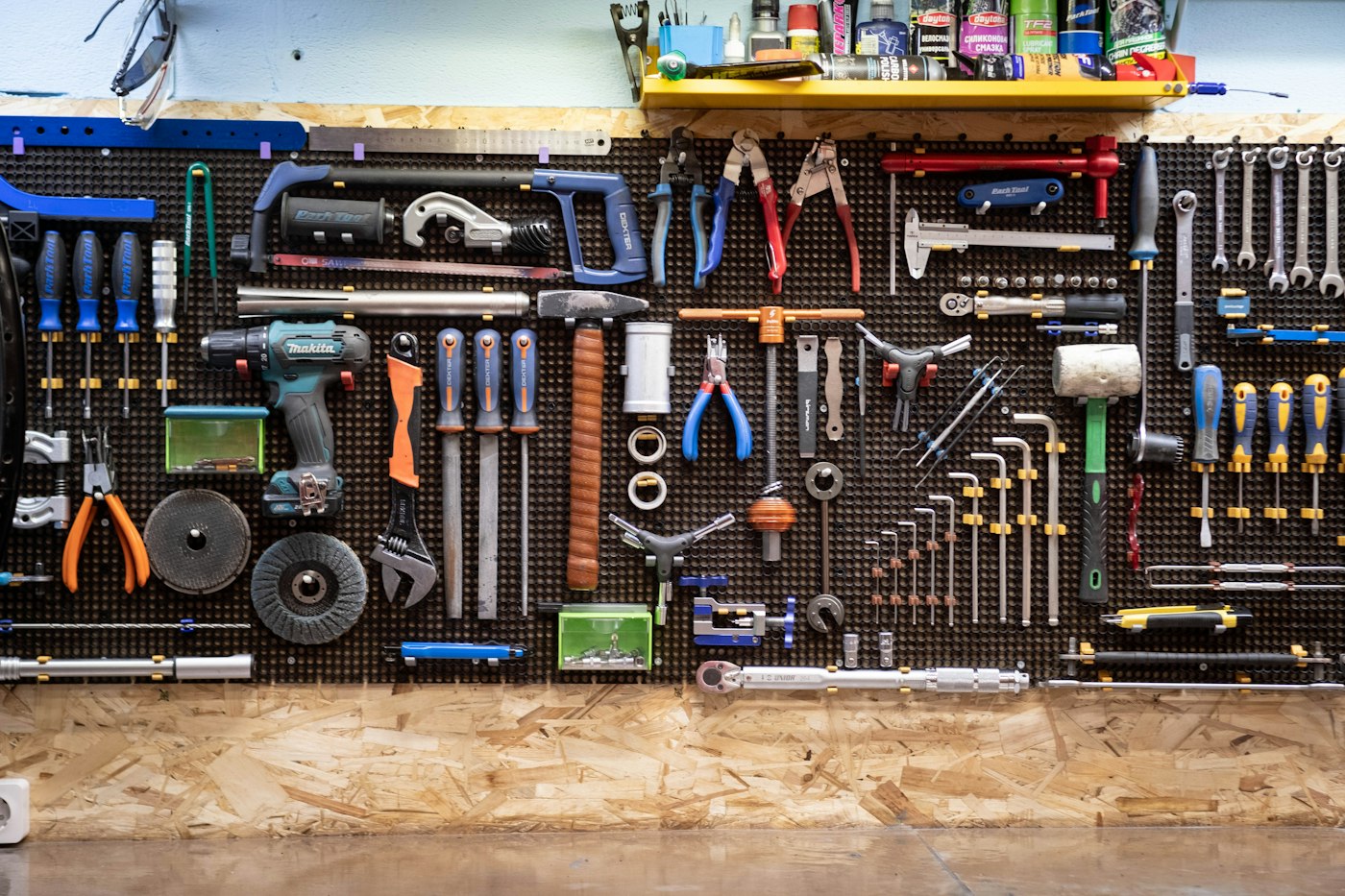 A tidy pegboard wall of hand tools in a workshop